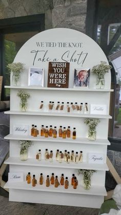 there is a display with bottles and flowers on it