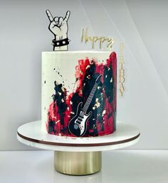 a birthday cake with an electric guitar on top