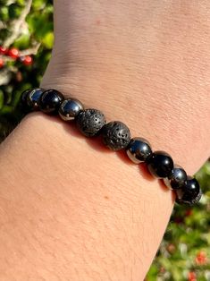 A bracelet made with a combination of Obsidian, Lava Stone, and Hematite is believed to offer powerful grounding, protection, and balancing metaphysical properties. Obsidian is known for its protective qualities, shielding against negativity and psychic attacks. It is thought to absorb negative energies and provide deep grounding, helping to release emotional blockages and promote emotional healing. Lava Stone is renowned for its grounding and calming properties. Formed from volcanic rock, it is believed to provide strength and courage, helping individuals stay connected to the Earth. Lava Stone is also said to aid in releasing anger and promoting emotional tranquility, often used in aromatherapy by adding essential oils to its porous surface. Hematite is associated with balance and focus. Releasing Anger, How To Release Anger, Psychic Attacks, Psychic Attack, Volcanic Rock, Lava Stone, Stay Connected, Emotional Healing, Crystals And Gemstones