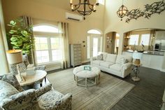 a living room filled with furniture and lots of windows