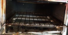 an old oven with the door open and rusting on it's racks,