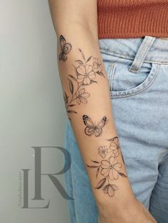 a woman with a butterfly tattoo on her arm