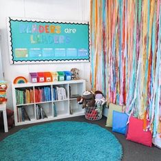 a child's room with colorful drapes and rugs on the floor, bookshelves in the background