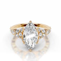 a yellow gold ring with a pear shaped diamond