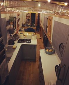 an overhead view of a kitchen and living room in a tiny house with wood floors