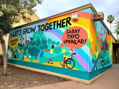 a mural on the side of a building that says let's grow together, sabay tayo umulad