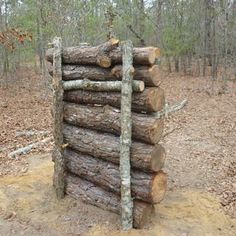 logs stacked on top of each other in the woods