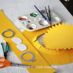 scissors, tape and other crafting supplies on a table