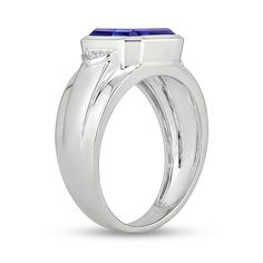 Add a pop of color to his tailored looks with this vibrant fashion ring. Crafted in sterling silver, this choice features a 10.0mm bezel-set cushion-cut bright blue lab-created sapphire. Diamond-accented collars flank the center stone while the tapered shank glistens with stepped borders for added depth. Buffed to a brilliant luster, this ring is sure to be noticed. Blue Emerald Cut Rings With Bezel Setting, Blue Emerald Cut Ring With Bezel Setting, Timeless Blue Signet Ring With Polished Finish, Timeless Blue Gemstone Signet Ring, Formal Sterling Silver Rings With Bezel Setting, Modern Blue Sapphire Ring For Formal Occasions, Modern Platinum Gemstone Rings, Modern Sapphire Signet Ring For Formal Occasions, Formal Sapphire Signet Ring With Polished Finish