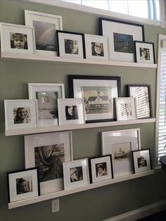 a wall filled with pictures and framed photos