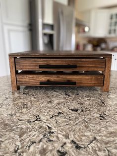 a wooden coffee table on top of a granite counter