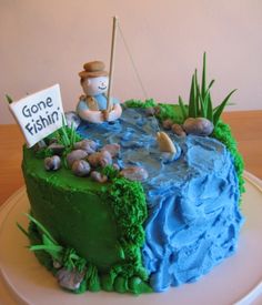 there is a cake that looks like it has been made to look like a fishing scene