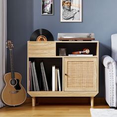 an entertainment center with a guitar, record player and other items