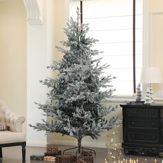 a silver christmas tree in a living room