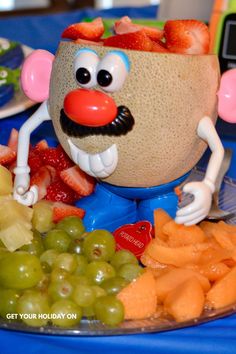 a close up of a plate of food with grapes and strawberries on the side