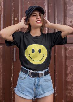 Smiley face shirt. So soft, so lightweight, so comfortable, so chic! This is a unisex fit. Size up for an oversized look or stay true to size for a classic fit. * 100% combed and ring-spun cotton  This product is made to order just for you! Please allow 2-7 business days for processing plus shipping time. Cheap Fun Smiley Face T-shirt, Funny Print Crew Neck T-shirt For Streetwear, Fun Short Sleeve T-shirt For Streetwear, Fun Everyday Short Sleeve T-shirt, Black Relaxed Fit Funny T-shirt, Black Crew Neck Top With Smiley Face, Black Smiley Face Crew Neck T-shirt, Cute Black Short Sleeve T-shirt, Black Smiley Face Crew Neck Top