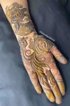 a woman's hand with hennap and flowers on her arm, showing the intricate