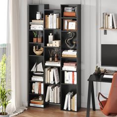 a black bookcase filled with lots of books next to a desk and chair in front of a window