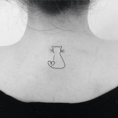 a woman's back neck with a cat tattoo on the left side of her neck