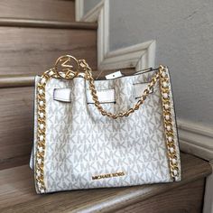 Nwt Michael Kors Mina Small Belted Chain Shoulder Crossbody Bag Mk Light Cream Crossbody Bag Logo-Print Canvas 89.4% Coated Canvas/9.6% Polyester/1% Polyurethane Trim 1: 52% Polyurethane/48% Polyester Trim 2: 60% Polyurethane/20% Cotton/20% Polyester Gold-Tone Hardware 8.25"W X 6.75"H X 3.5"D Interior Details: 3 Back Card Slots Lining: 100% Polyester Snap Fastening Imported Orange Handbag, Light Cream Color, Bag Logo, Luxurious Fashion, Michael Kors Crossbody Bag, Quilted Crossbody Bag, Overnight Bags, Michael Kors Crossbody, Leather Handbags Crossbody