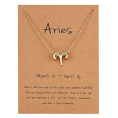 the aries zodiac sign necklace is displayed on a card