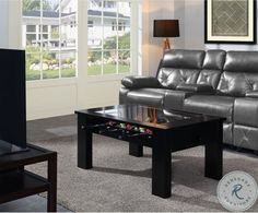 a living room scene with focus on the couch and coffee table in front of the television