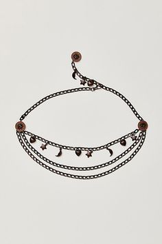 Give your waist some celestial charm with this chain belt, featured in a chunky, multi-strand design with moon, star, and heart motifs. **Features:** Chain style, multi-strand design, leather pieces with metal sun details, celestial charms, clasp closure, adjustable fit **Why We | Shoot For The Stars Chain Belt by Free People in Brown Shoot For The Stars, Star Chain, Bronze Age, Chain Belt, Leather Pieces, Moon Star, Shooting Stars, Multi Strand, Chain Styles