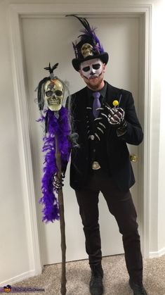 a man wearing a skeleton mask and holding a stick