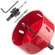 a red circular hole puncher with two holes in the center and one hole sawing tool attached to it