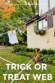 trick or treat web banner with clothes pins and streamers in front of a house