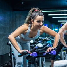 a man and woman working out on exercise bikes