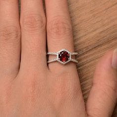 It is a natural garnet ring. The main stone is 7mm*7mm round cut, weight about 1.68 carats. The basic metal is sterling silver and plated with rhodium. To change the metal to a solid gold (white/rose) or platinum is also available, please ask for a quotation if you want. You can also go to my shop Home for more elegant rings: https://www.etsy.com/shop/godjewelry?ref=hdr_shop_menu More natural garnet rings: https://www.etsy.com/shop/godjewelry?ref=seller-platform-mcnav&section_id=20709242 Cus Classic Garnet Jewelry With Halo Setting, Round Garnet Promise Jewelry, Red Garnet Round Band Jewelry, Garnet Ruby Ring For Promise, Round Garnet Jewelry For Promise, Garnet Halo Setting Rings In Fine Jewelry, Round Garnet Ring With Halo Setting, Round Garnet Jewelry With Halo Setting, Red Garnet Promise Jewelry