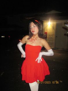 a woman dressed in red and white posing for the camera