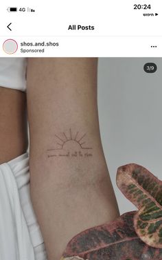 a small sun tattoo on the right side of the arm, with words written in cursive font