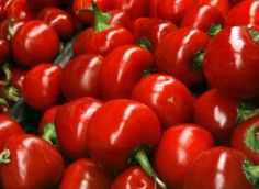 many red peppers are piled up together