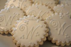 decorated cookies with white frosting on a plate