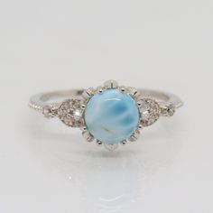 Vintage Sterling Silver Natural Larimar & White Topaz Ring...Marked 925...Total of weights 2.1gramsSize 10...Measure of Face 8.7MM...It's in very good condition. Larimar Turquoise Gemstone Ring For Anniversary, Elegant Oval Larimar Rings, Wedding Larimar Gemstone Rings, Hallmarked Larimar Jewelry, Sterling Silver Topaz Ring With Diamond Accents, Elegant Larimar Rings For Anniversary, Larimar Gemstone Jewelry For Wedding, Stamped 925 Blue Topaz Round Rings, Silver Turquoise Larimar Ring For Anniversary