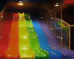 an indoor water slide is brightly colored in the dark