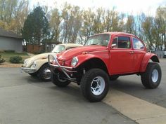 two old cars are parked next to each other