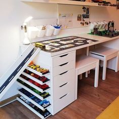 a desk with drawers underneath it and some shelves above the desk that hold various items