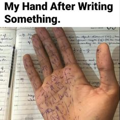 a hand with writing on it next to an open notebook and pen, which reads nobody my hand after writing something