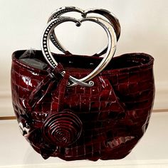 This High Gloss Croco Patent Leather Purse From Brighton Is A Rich Dark Burgundy Red Color. Box And Dust Cloth Included; Never Used; Bought And Stored; No Flaws; Pre-Loved Condition. Approximately 9.5”L X 8”H X 4”W Elegant Leather Bags For Valentine's Day, Elegant Leather Shoulder Bag For Valentine's Day, Elegant Bags With Removable Pouch For Valentine's Day, Elegant Bags For Valentine's Day Shopping, Elegant Burgundy Shoulder Bag With Handles, Elegant Red Bags With Silver-tone Hardware, Elegant Burgundy Bag With Silver-tone Hardware, Luxury Shopping Bags For Valentine's Day, Designer Red Bags For Valentine's Day