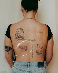 the back of a woman's body with tattoos on her upper and lower half