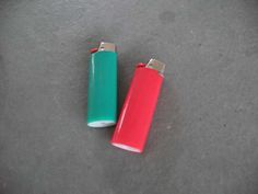 two colorful lighters sitting next to each other