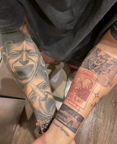 two people are holding hands with tattoos on their arms and arm, one has an image of a man's face