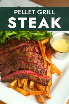 a plate with steak, french fries and lettuce on it that says pellet grill steak