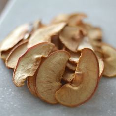 sliced apples are sitting on a white surface