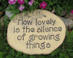 a stone that says how lovely is the alliance of growing things