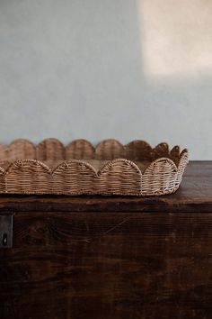 a wicker basket sitting on top of a wooden table