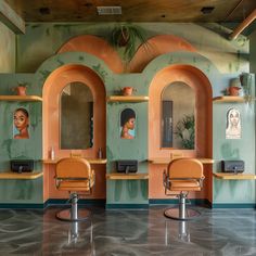 the interior of a hair salon with two chairs and mirrors on the wall above them